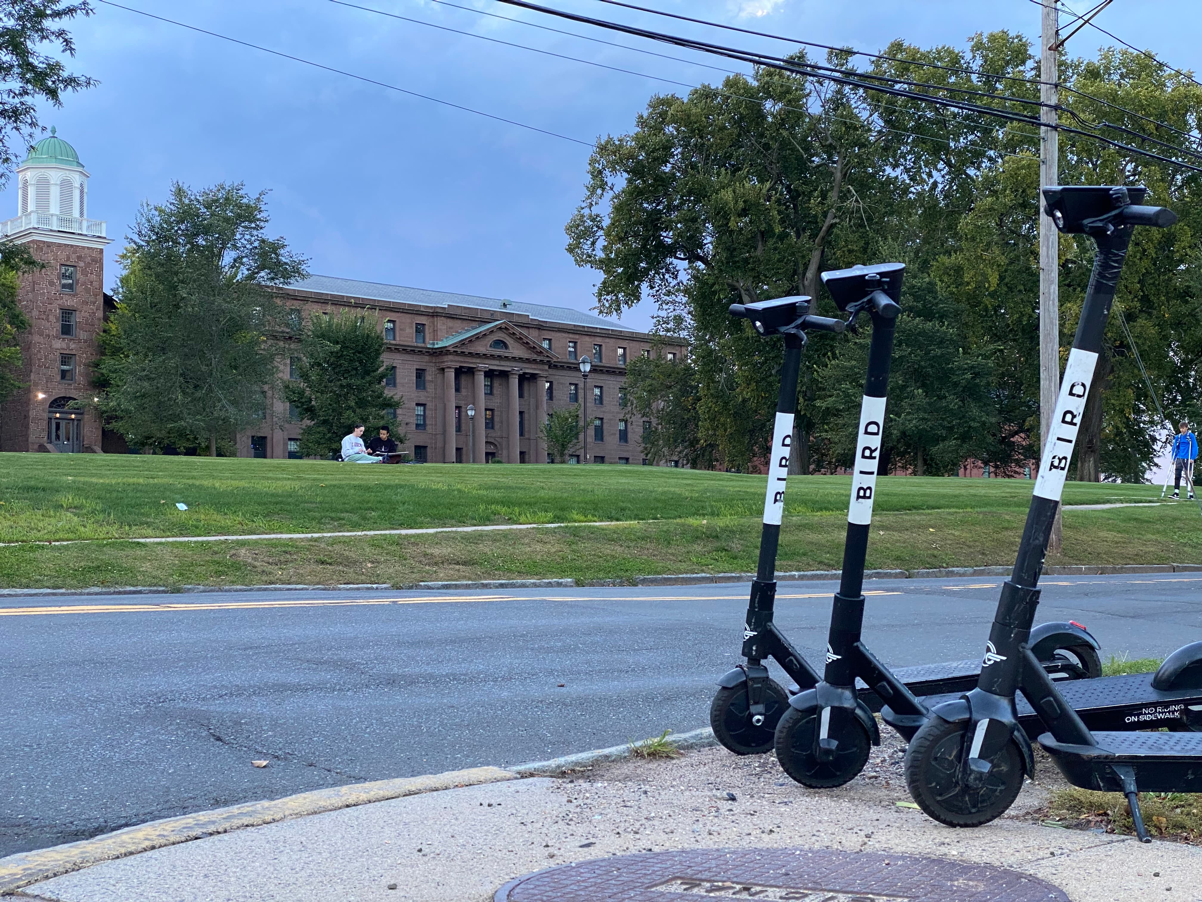Three Bird Scooters with Wesleyan North College in the background
