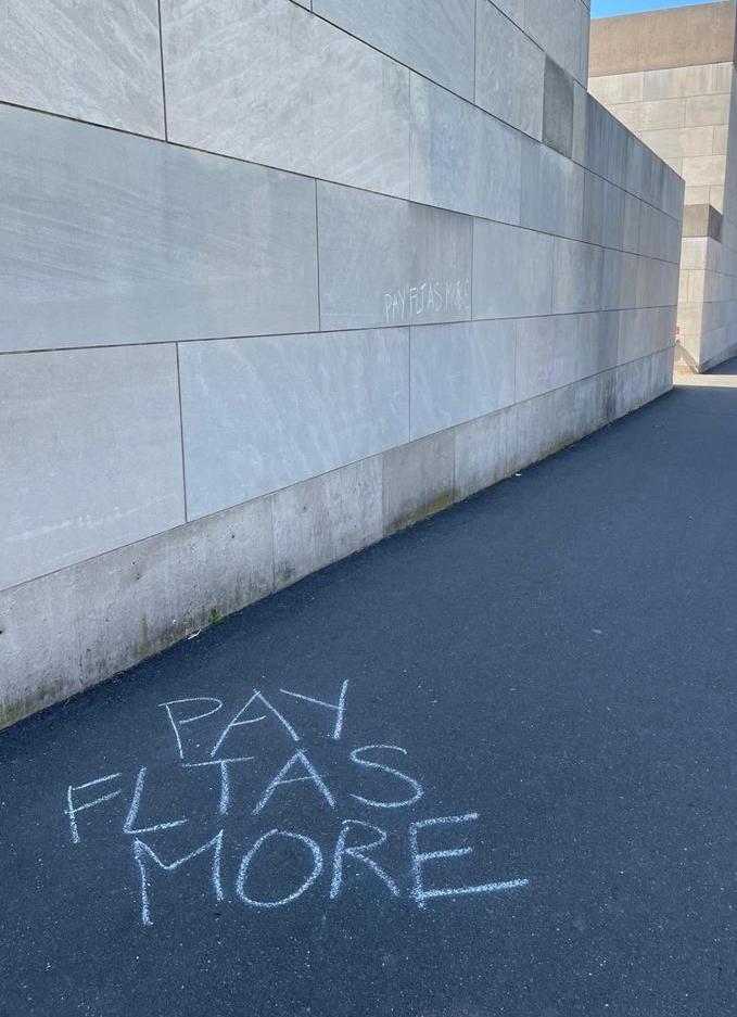 Chalking "Pay FLTAS More" in the Arts Center
